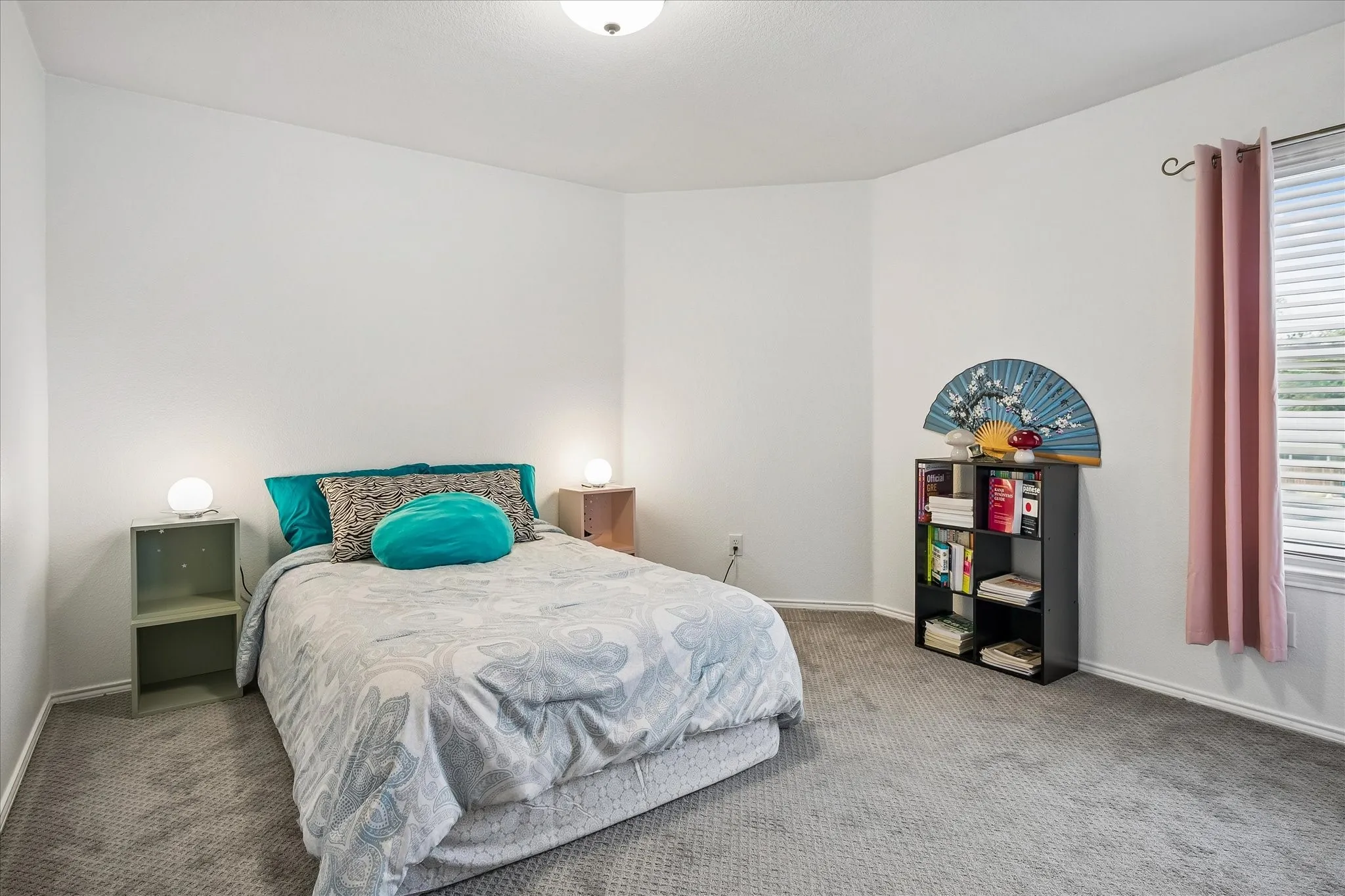 Wall-to-wall carpeting with light-toned walls and a corner window