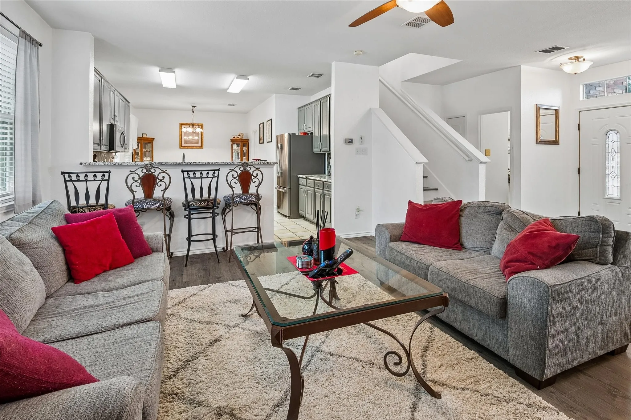 Open-concept living area featuring wood-finish flooring
