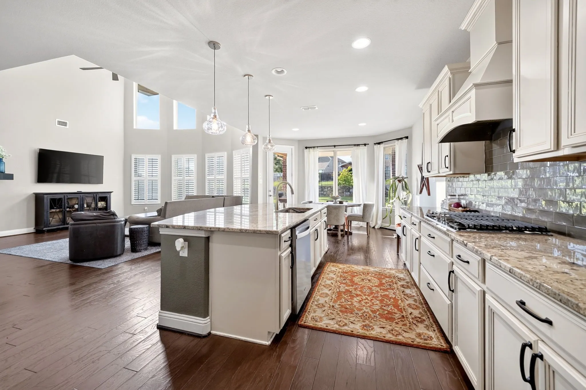 Open-concept kitchen and living area featuring wood-finish flooring