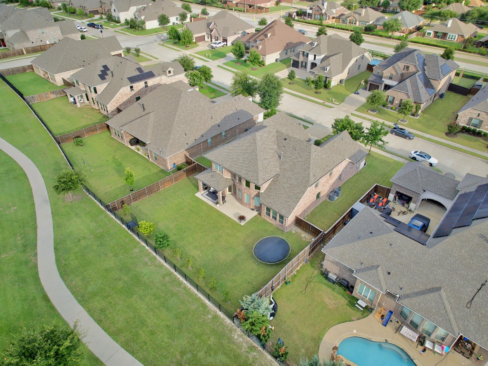 Aerial perspective showcasing a residential neighborhood with brick and siding exteriors