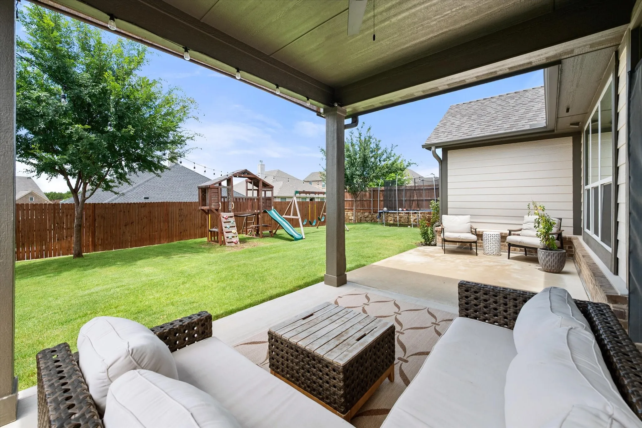 Relax under the covered patio in the backyard.