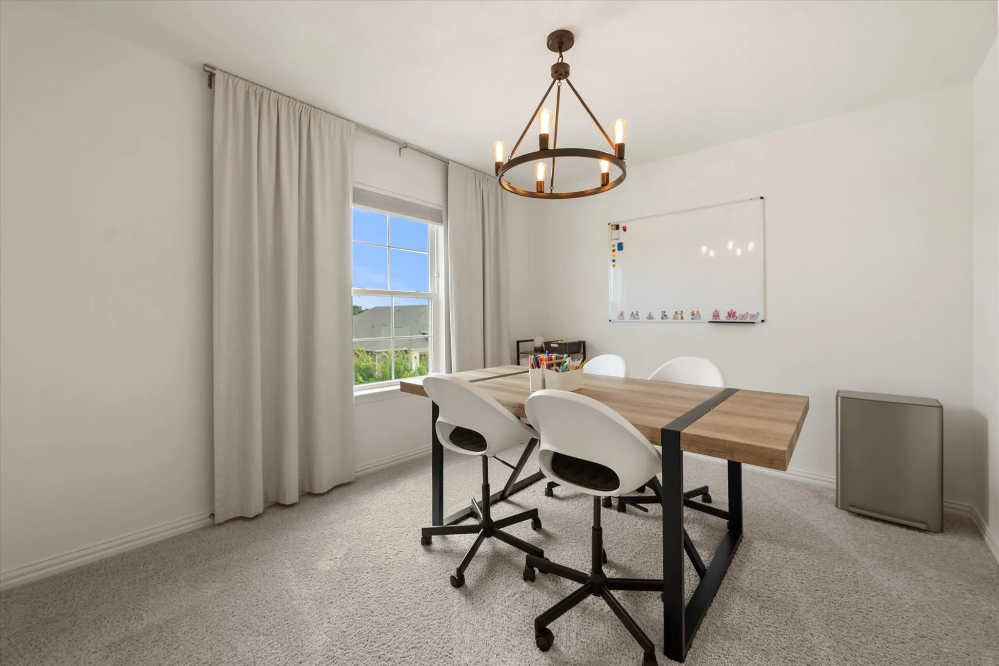 Bedroom #4 features a decorative chandelier and plush carpet.