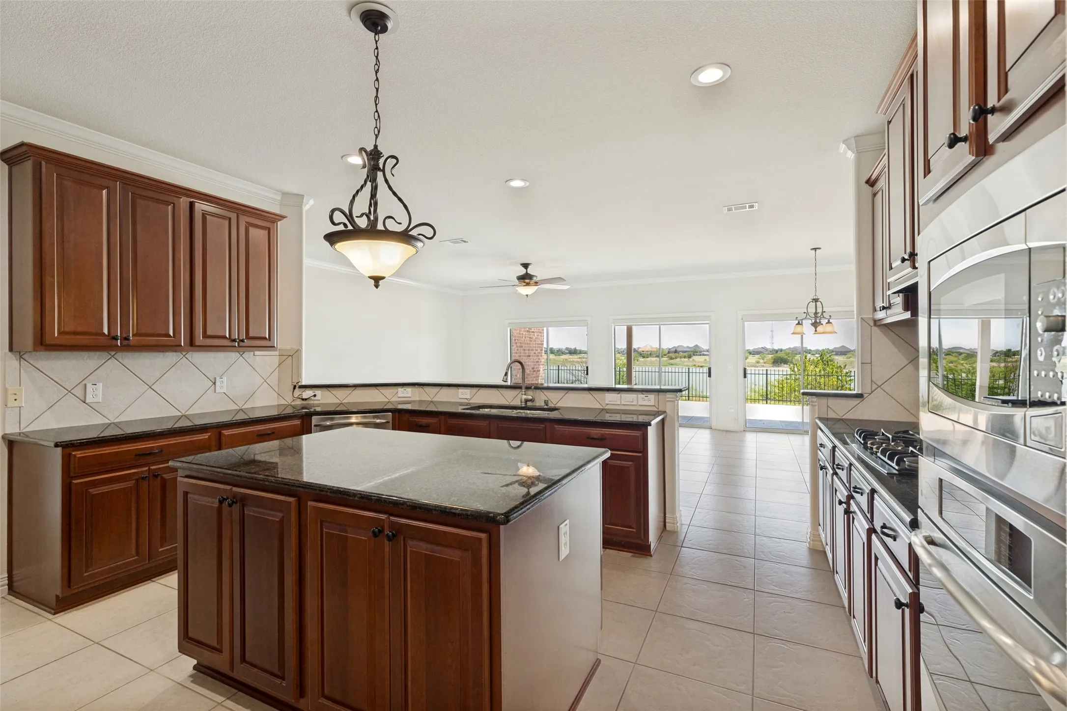 Gleaming Cherry Cabinets New Lighting shows off the Designer Paint Color and Stunning Granite Surfaces. Huge walk in Room Sized Pantry is a cooks dream.