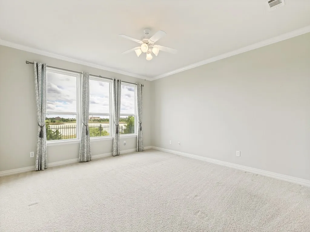 Tucked away at the back of the home, this primary suite has it all. Serene water views, beautiful private bathroom with a dual sided walk in closet.
