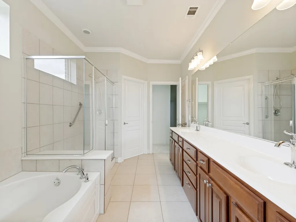 View of the Bath Tub and Separate Shower in the Ensuite Primary Bathroom.