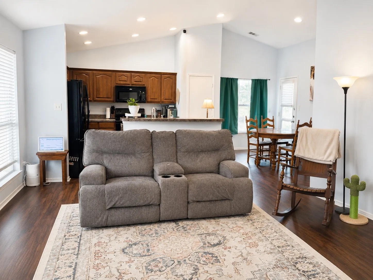 Open-concept living space featuring vaulted ceilings and recessed lighting
