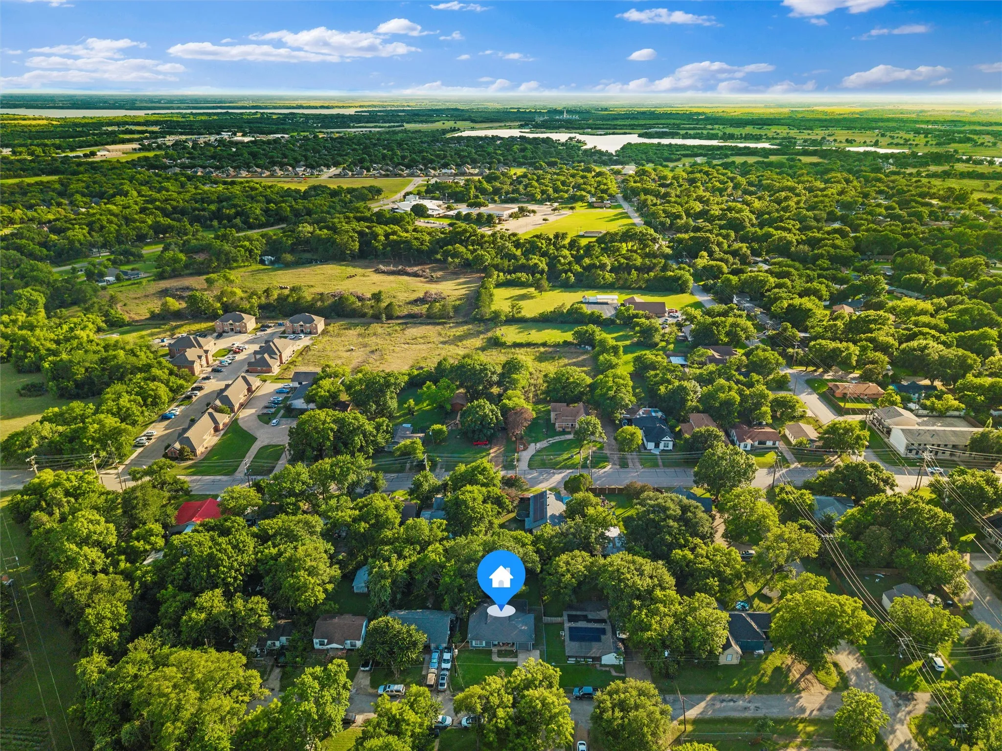 Aerial view showcases the surrounding neighborhood and convenient residential setting.