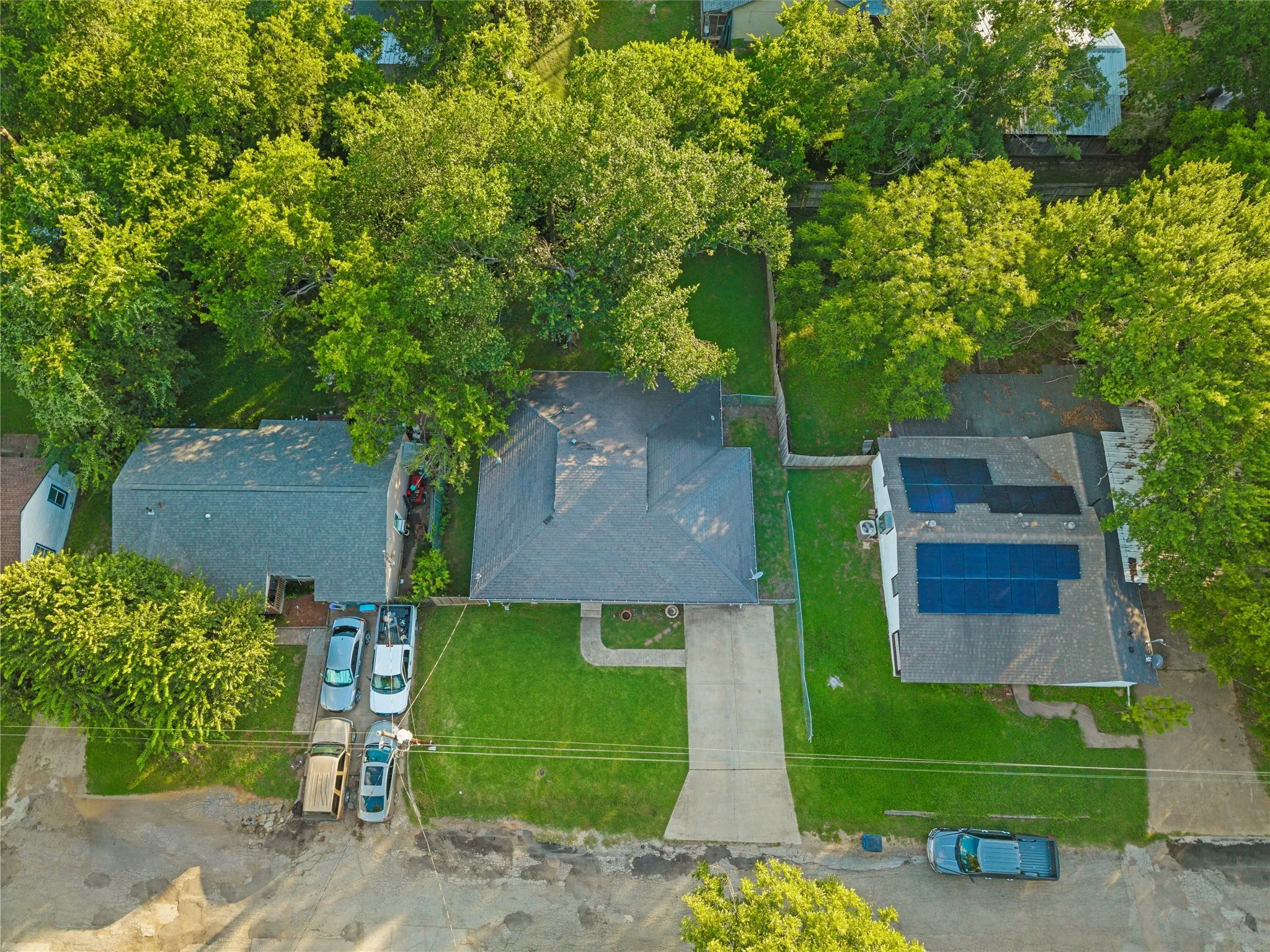 Aerial view highlights the property, surrounding residential streets, and mature tree canopy.