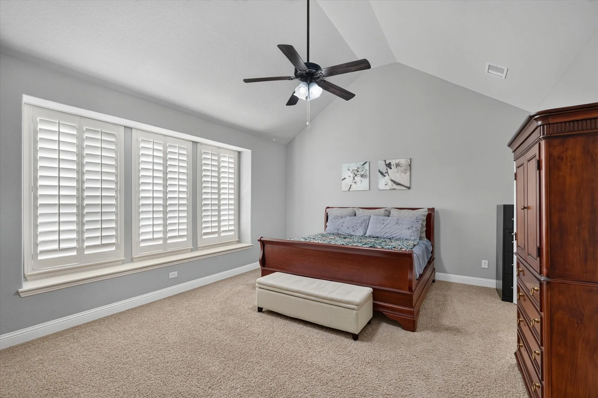 Room featuring vaulted ceilings and a ceiling fan