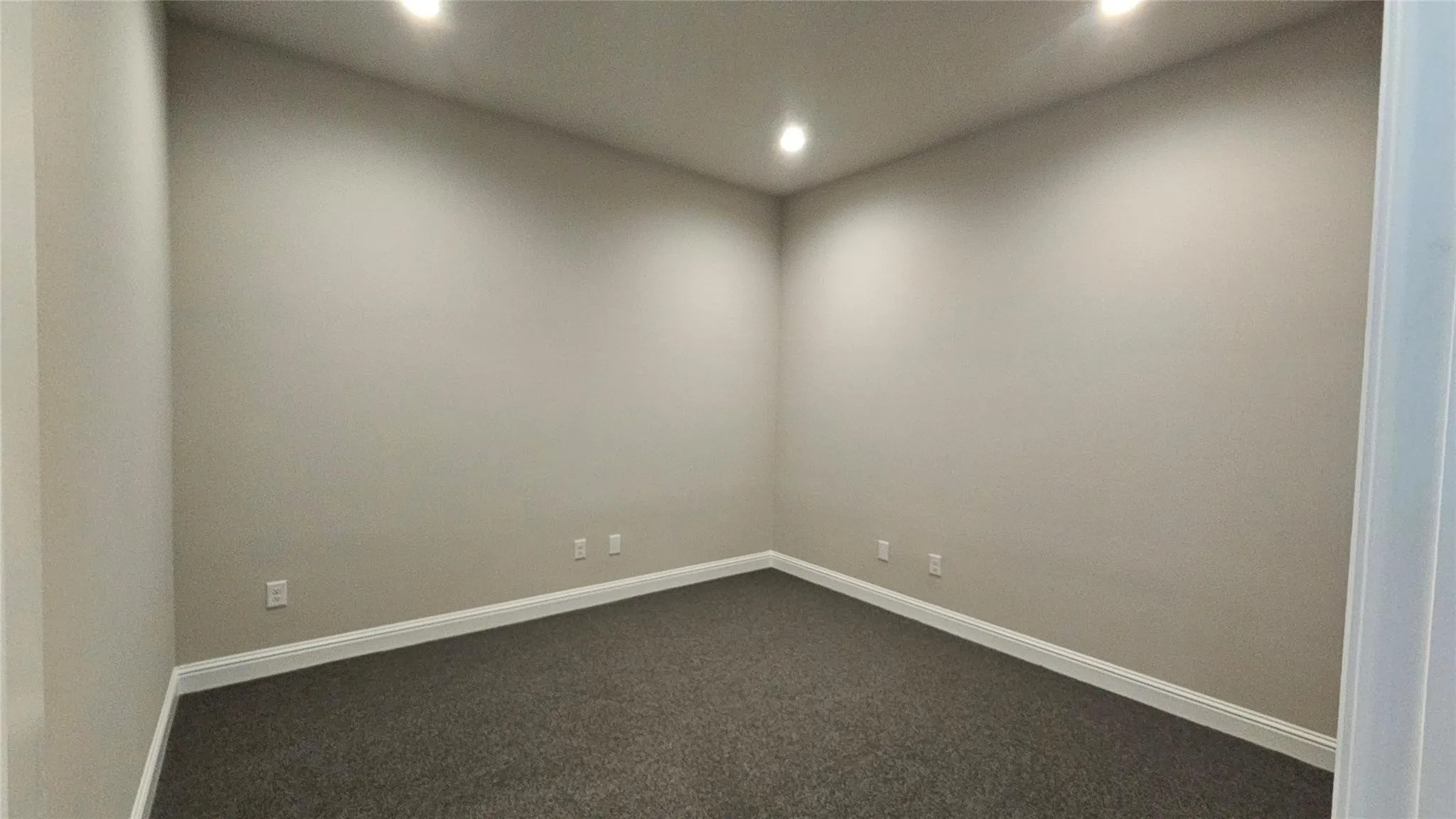 Neutral wall finishes, recessed lighting, white baseboards, and dark carpeting