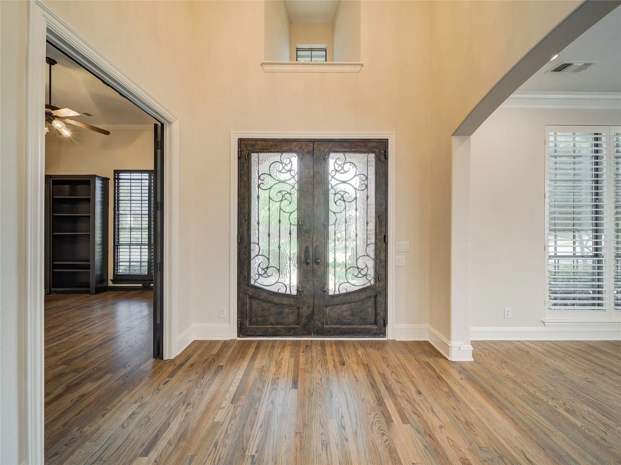 Grand double entry doors with wrought iron detailing