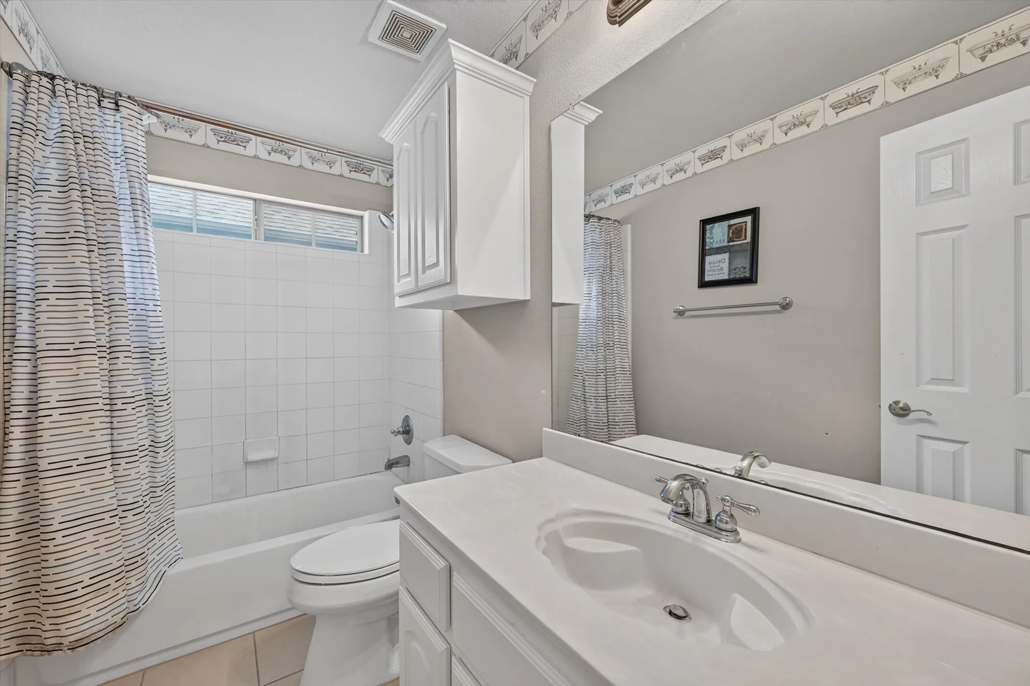 Vaulted ceiling bedroom featuring carpeting, a ceiling fan, and a window with blinds