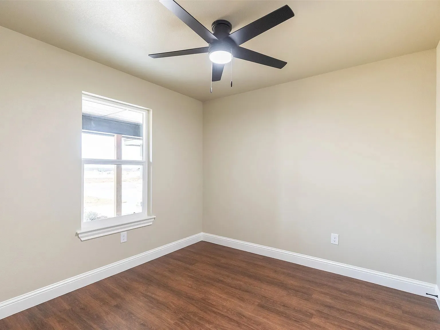 Neutral tone walls with white trim and wood-finish flooring