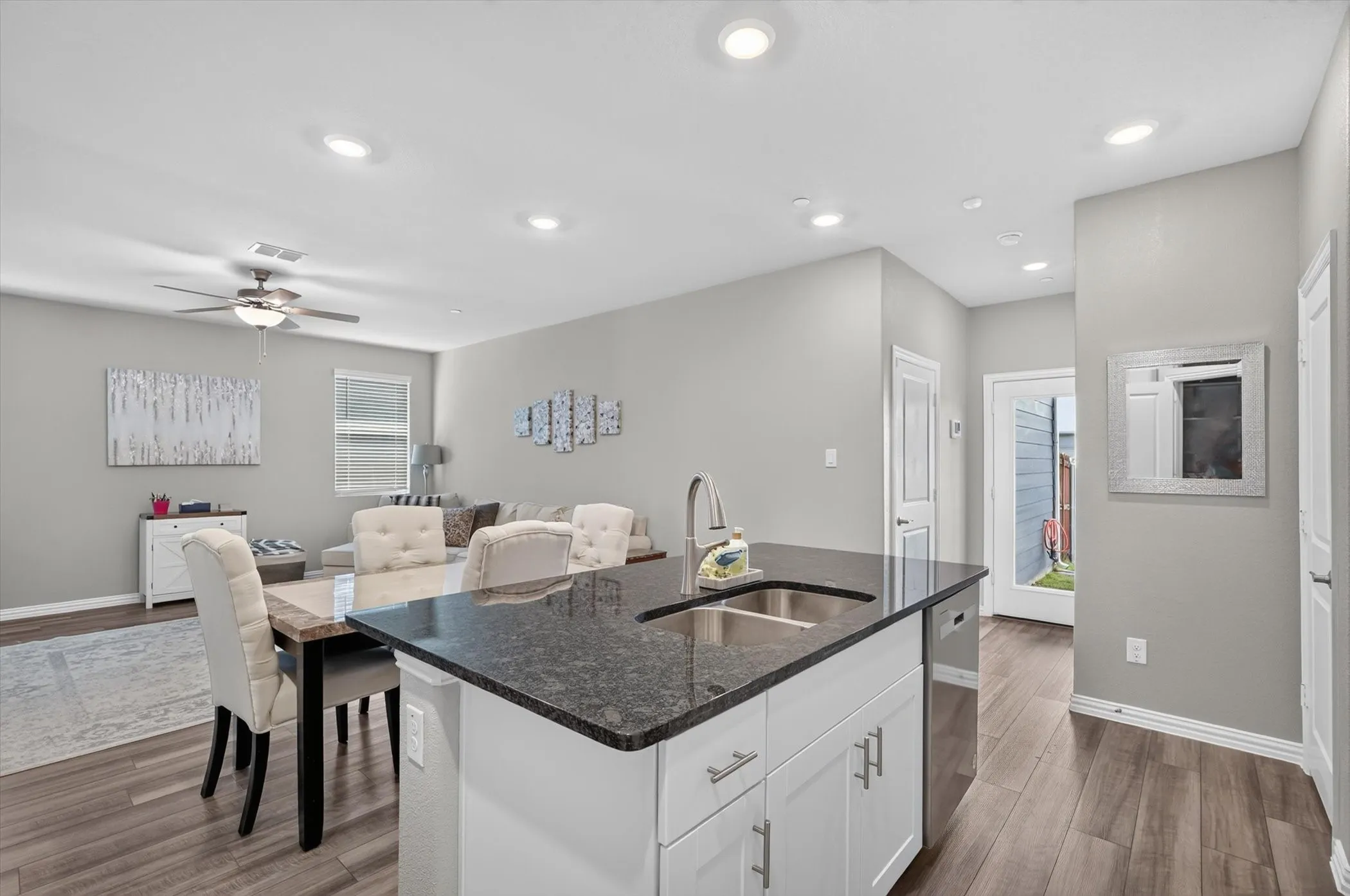 Kitchen island with dark countertop and double basin sink