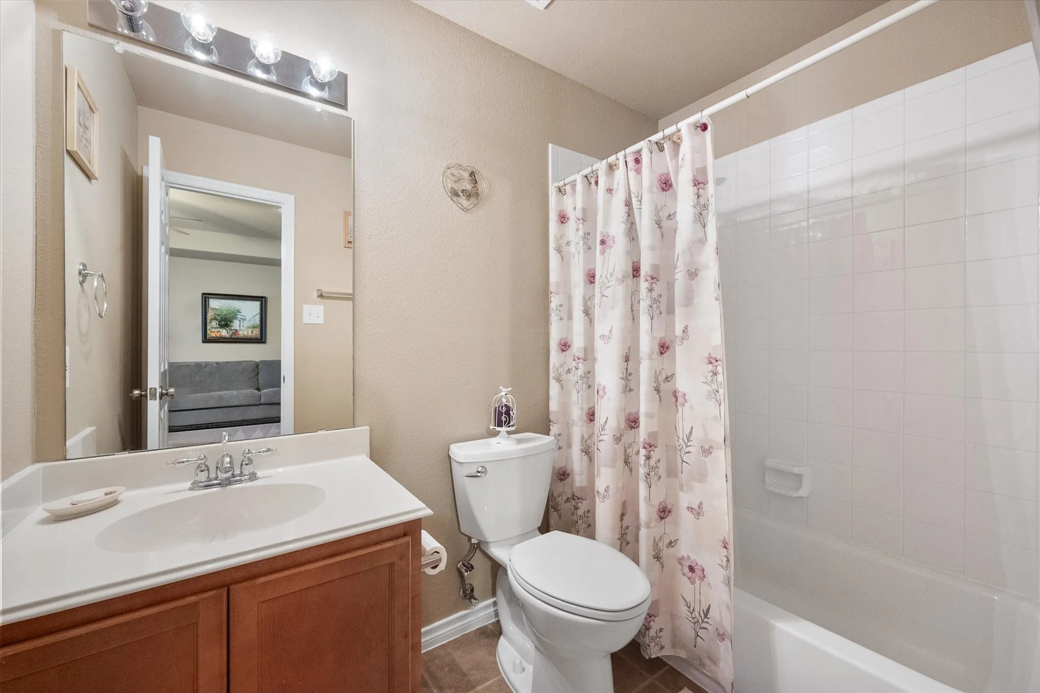 The upstairs guest bathroom is thoughtfully designed to provide comfort and convenience for family and visitors alike. This full bathroom features a single-sink vanity with ample cabinet storage, a tub/shower combination with a tiled surround, durable flooring, and a bright, neutral color palette that complements any décor. Ideally located near the upstairs secondary bedrooms and spacious gameroom, this well-appointed bath offers both functionality and privacy, making it perfect for guests, children, or everyday family living.