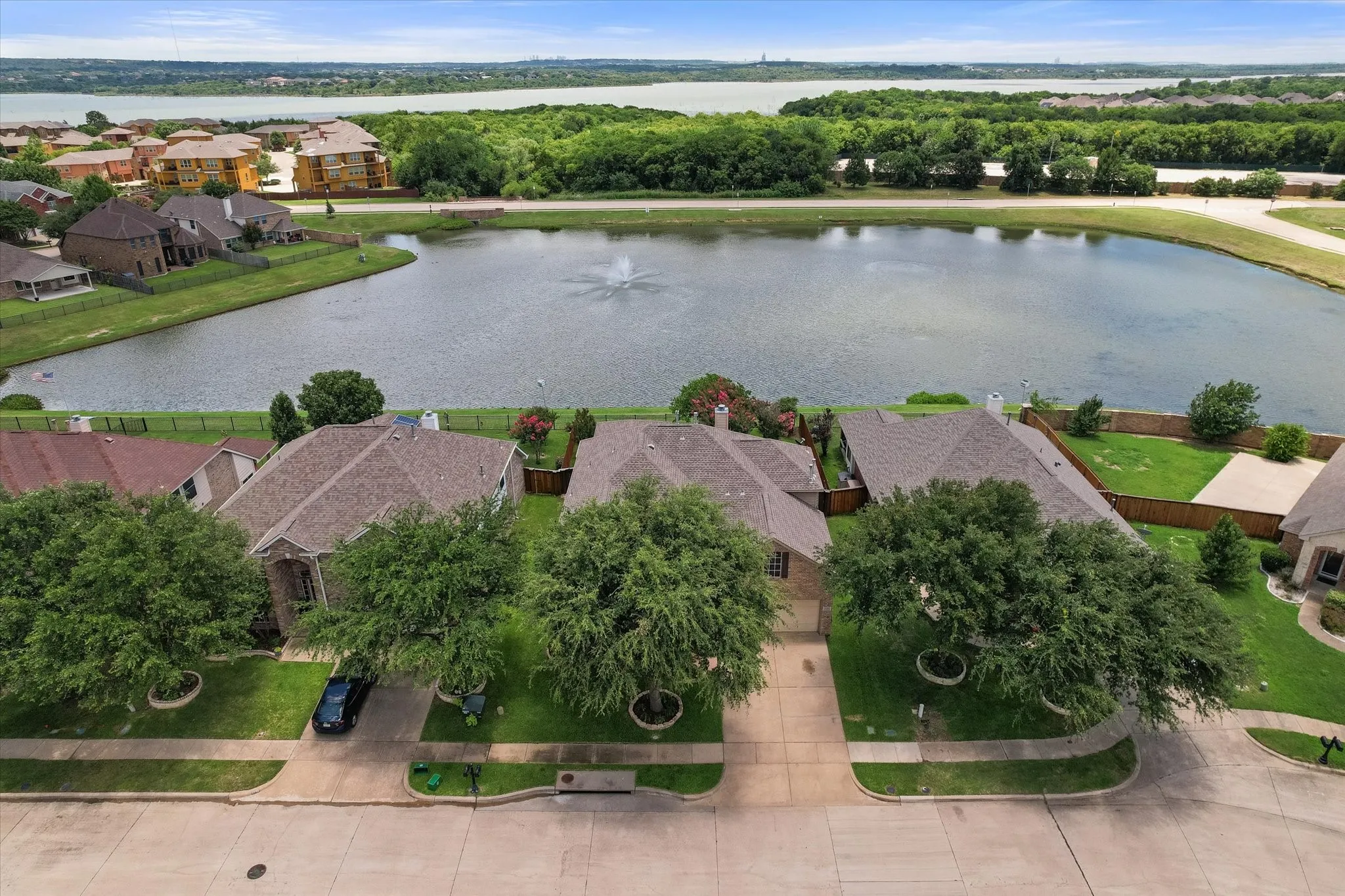 Enjoy an exceptional location in the highly desirable **Mira Lagos** community with this stunning **aerial view** showcasing the neighborhood's scenic **pond**, **lighted fountain**, and beautiful **greenbelt surroundings**. This home backs to a tranquil **water view**, offering enhanced privacy and picturesque views with no immediate rear neighbors. Beyond the neighborhood pond, residents enjoy close proximity to **Joe Pool Lake**, adding to the area's natural beauty and outdoor recreation opportunities. Nestled on a quiet street with mature trees and well-maintained homes, this sought-after location combines peaceful **waterfront-style living** with convenient access to parks, walking trails, shopping, dining, and major commuter routes. A rare opportunity to own a home in one of **Mira Lagos' premier pond-view locations**.