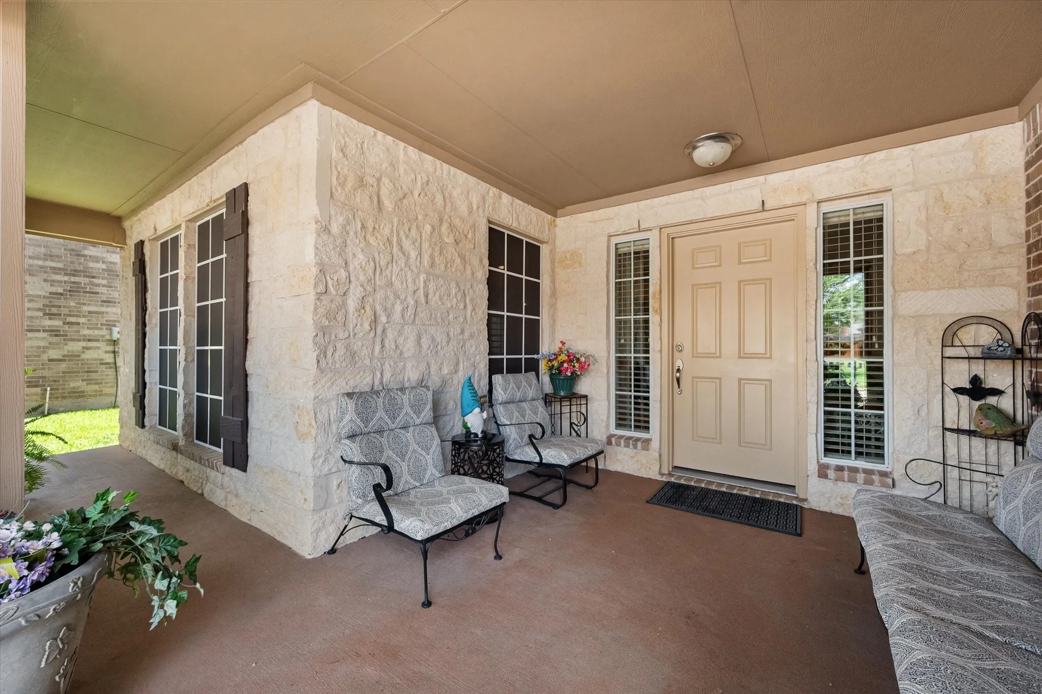 This close up view of the covered front porch highlights the size of the porch. There is ample room to enjoy guests.