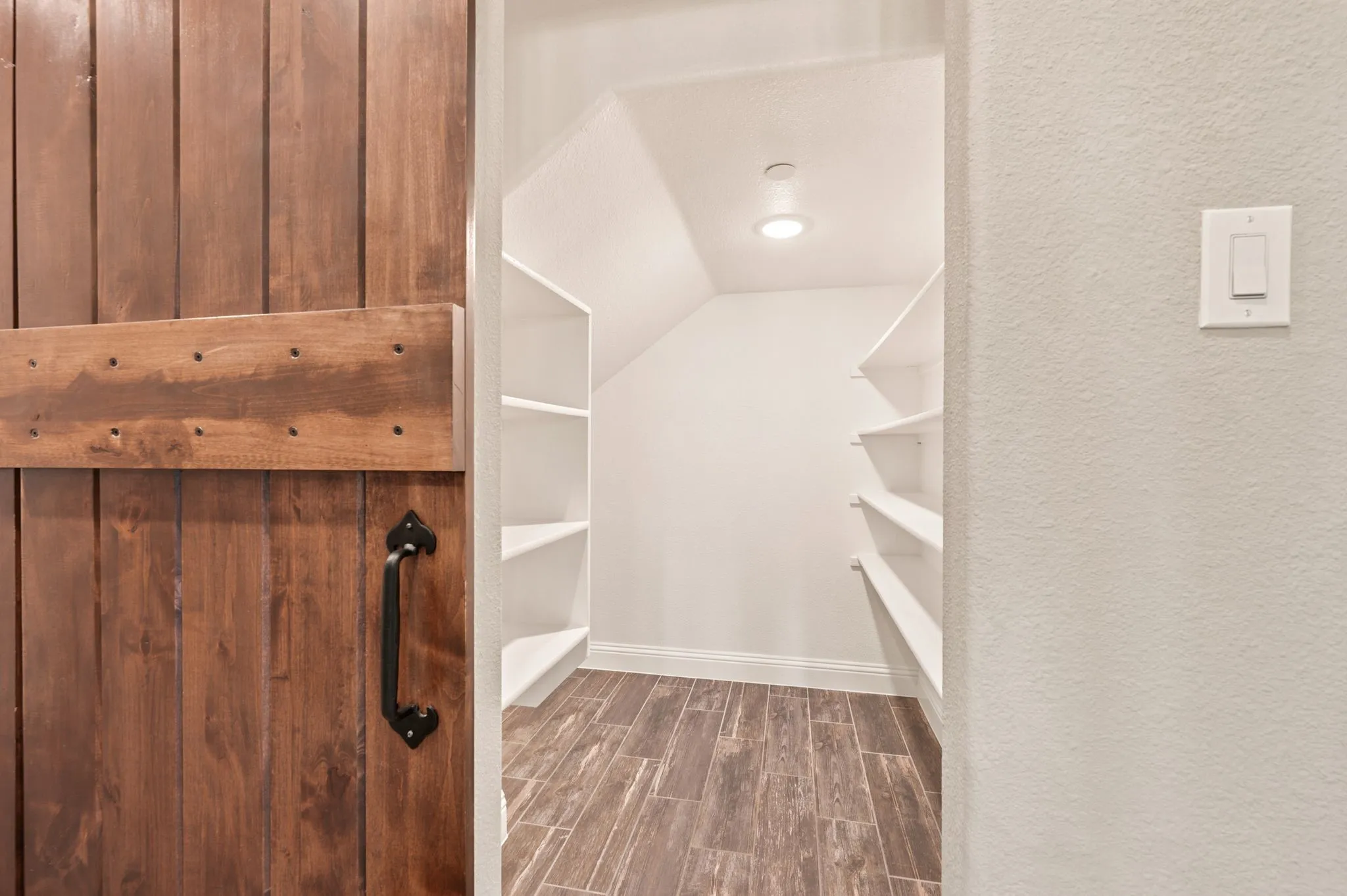 This huge pantry has a space saving barn door.