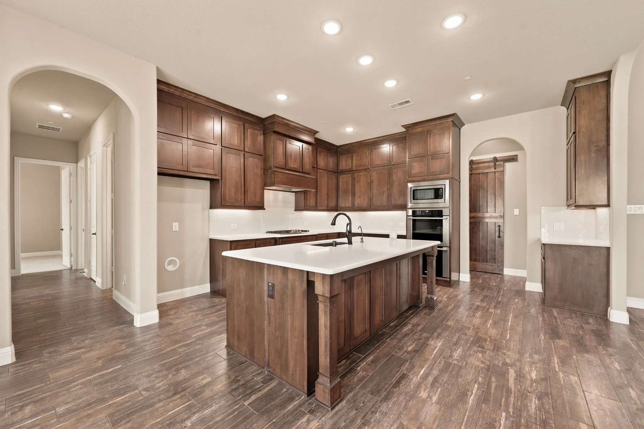 Custom cabinetry includes above and under cabinet lighting. Breakfast bar-island combination provides additional prep and seating space.