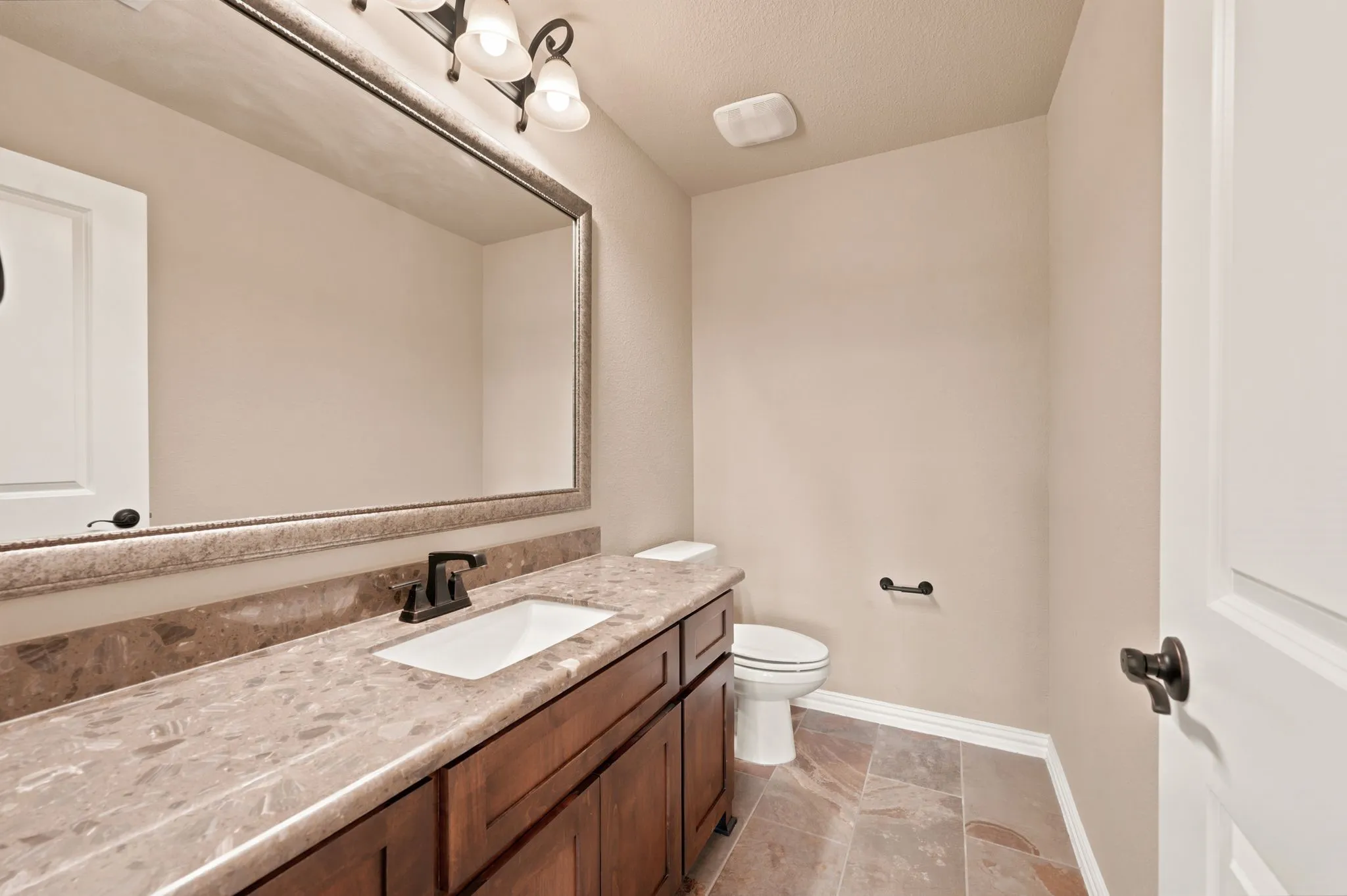 This half bath is located upstairs next to the game and media rooms.