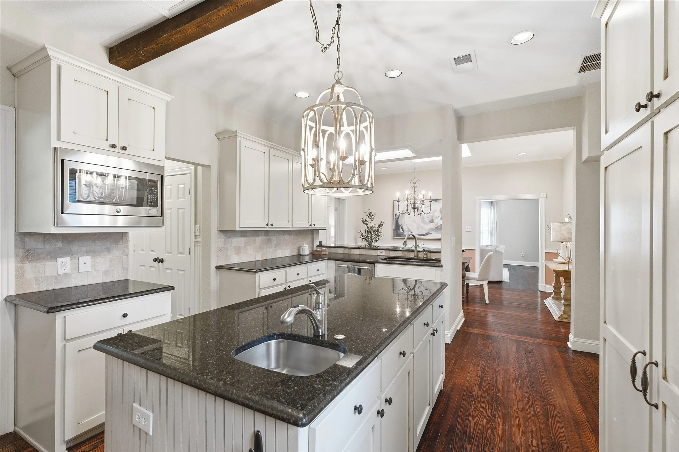 Beautiful kitchen with full sink and bar sink on expansive island