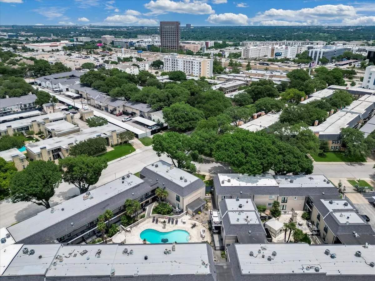Aerial perspective showcasing multiple residential buildings with surrounding green spaces