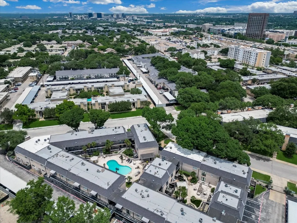 Aerial perspective showcasing multiple residential structures with grey shingle roofing