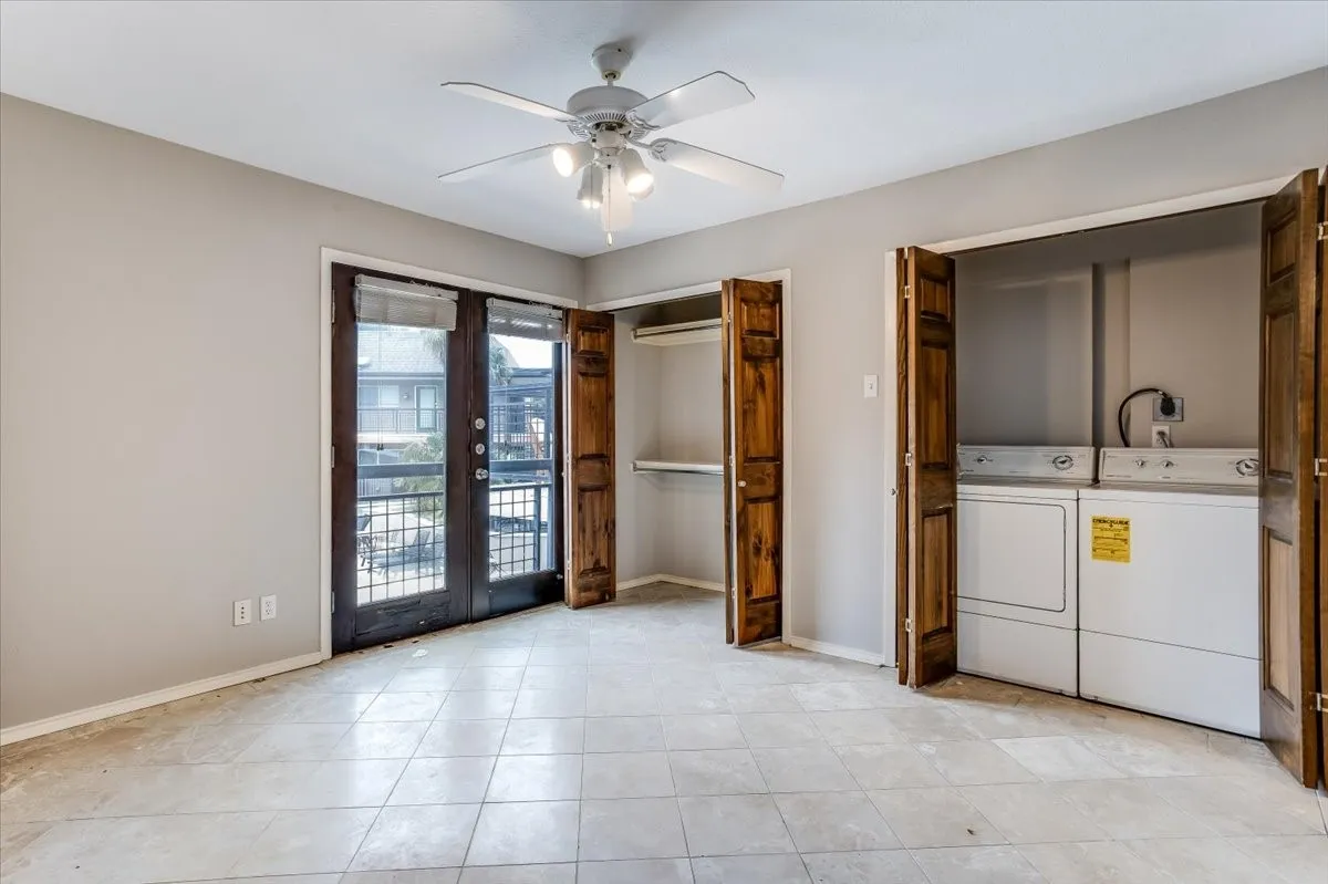 Tiled flooring extending throughout, complemented by a ceiling fan with integrated lighting
