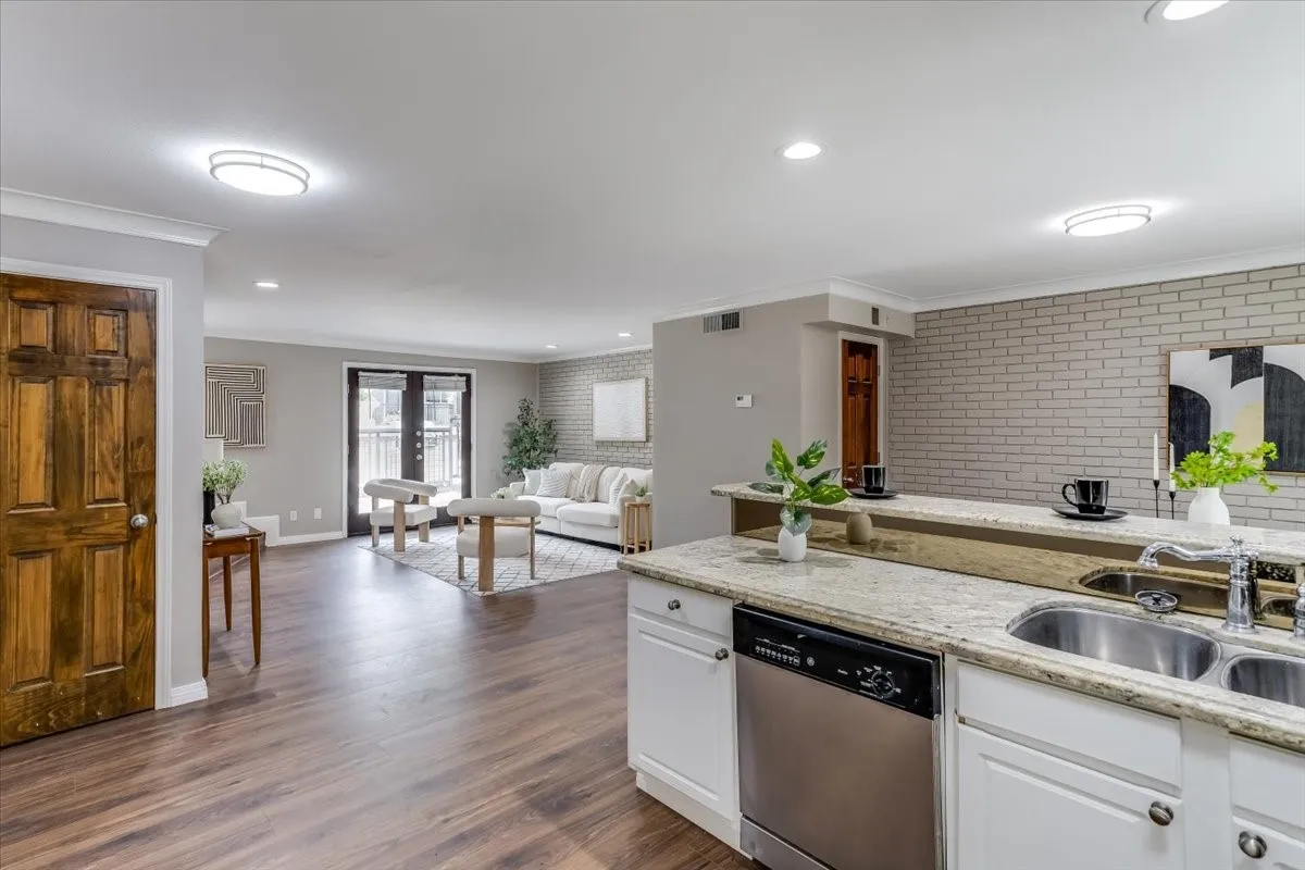 Kitchen with granite countertops, stainless steel dishwasher, and dual basin sink