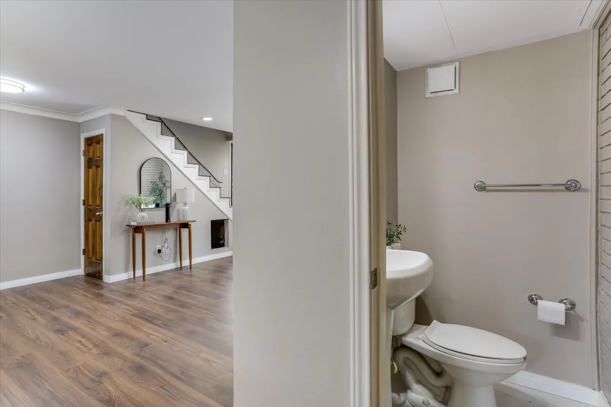 Warm wood-finish flooring extends through the main living area