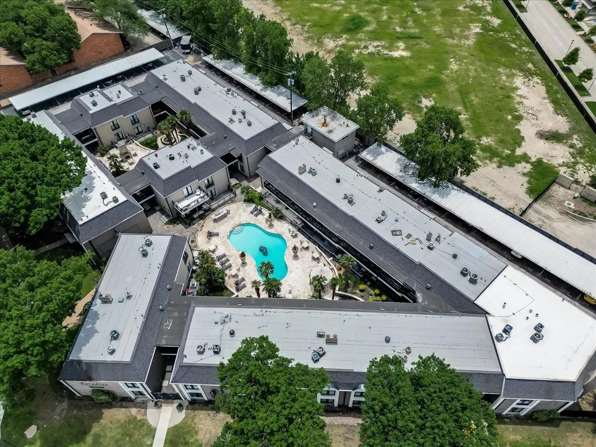 Multi-building residential complex featuring a central courtyard with a swimming pool