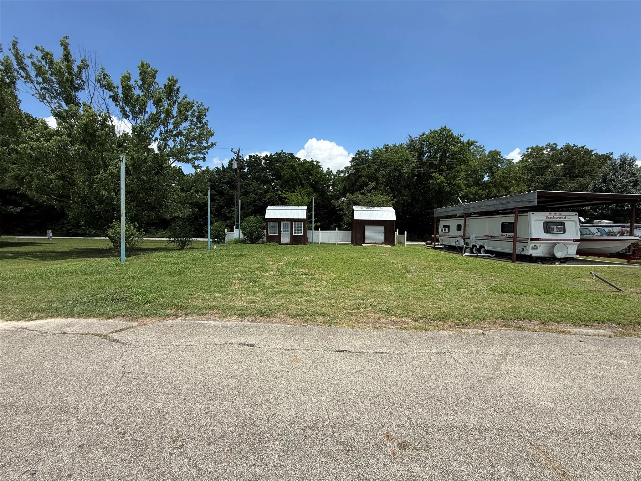 Wide road-front view of this improved Pelican Isle lot in Kerens.