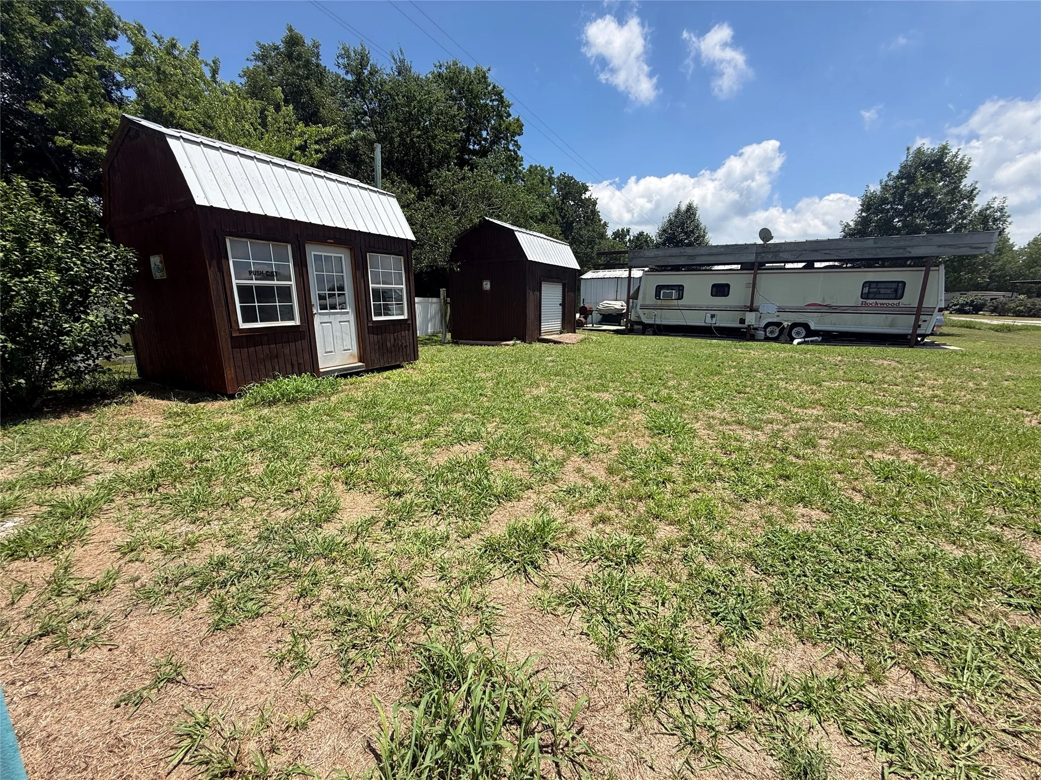 Front lot view with storage buildings.