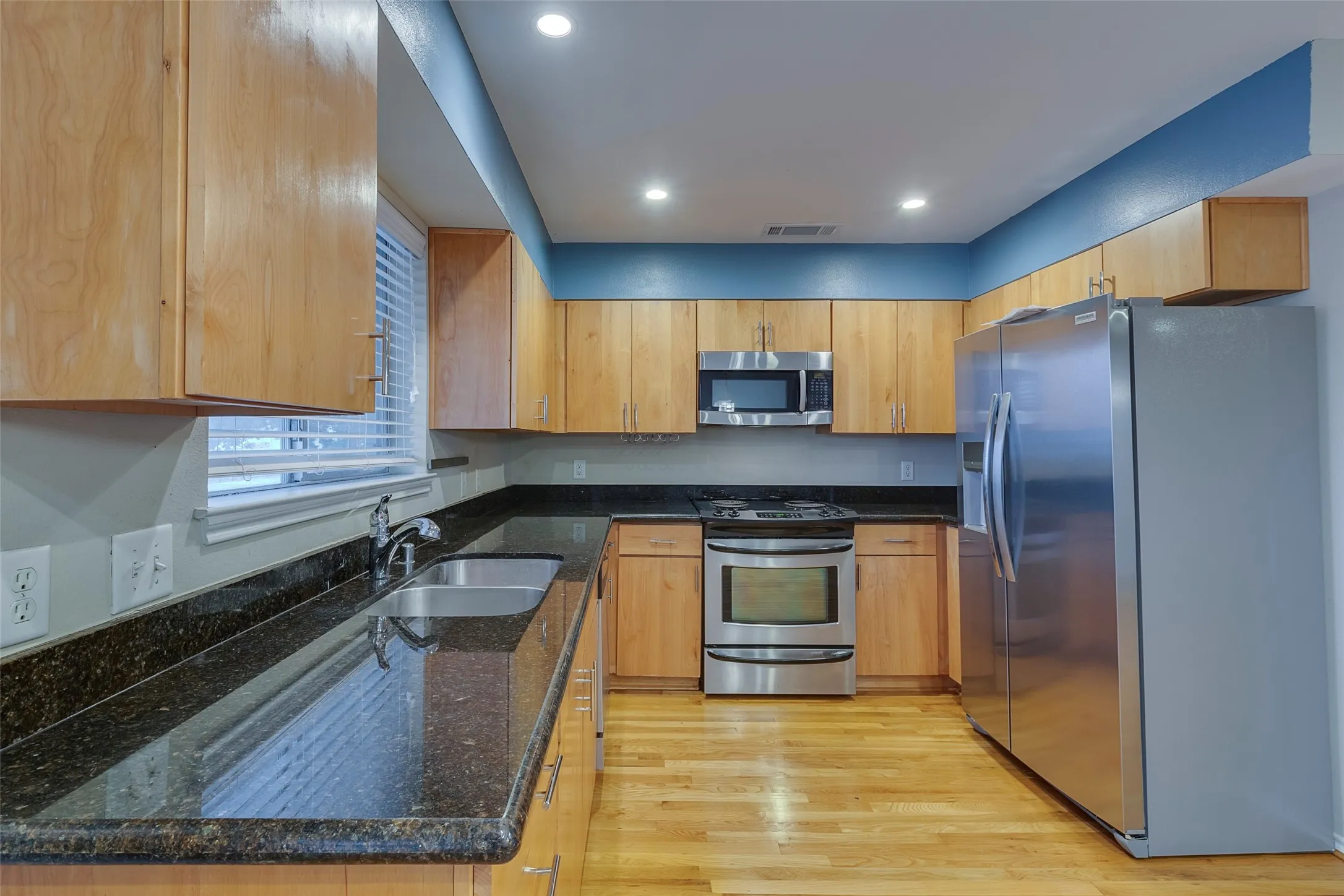 Kitchen with new stainless steel refrigerator