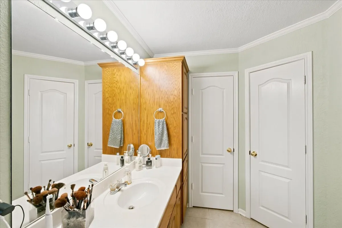 Bathroom featuring a vanity with a white countertop and two integrated sinks