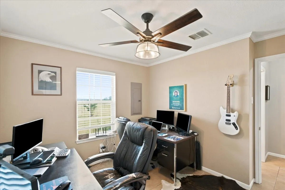 Room featuring crown molding, a window with horizontal blinds, and a ceiling fan with a light fixture