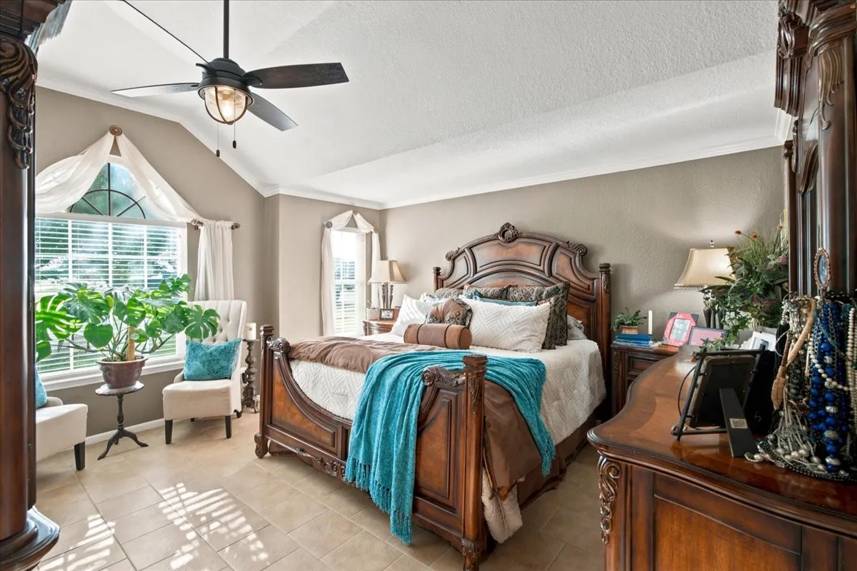 Spacious room featuring vaulted ceilings, recessed lighting, and tiled flooring