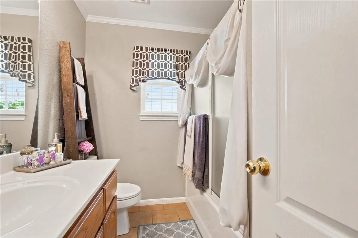 Bathroom featuring a single-sink vanity with wood-finish cabinetry and a white countertop