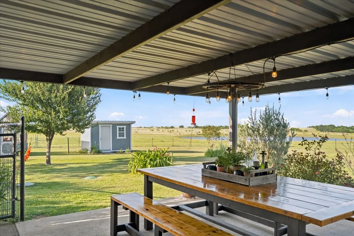 Covered patio with a corrugated metal roof and exposed support beams