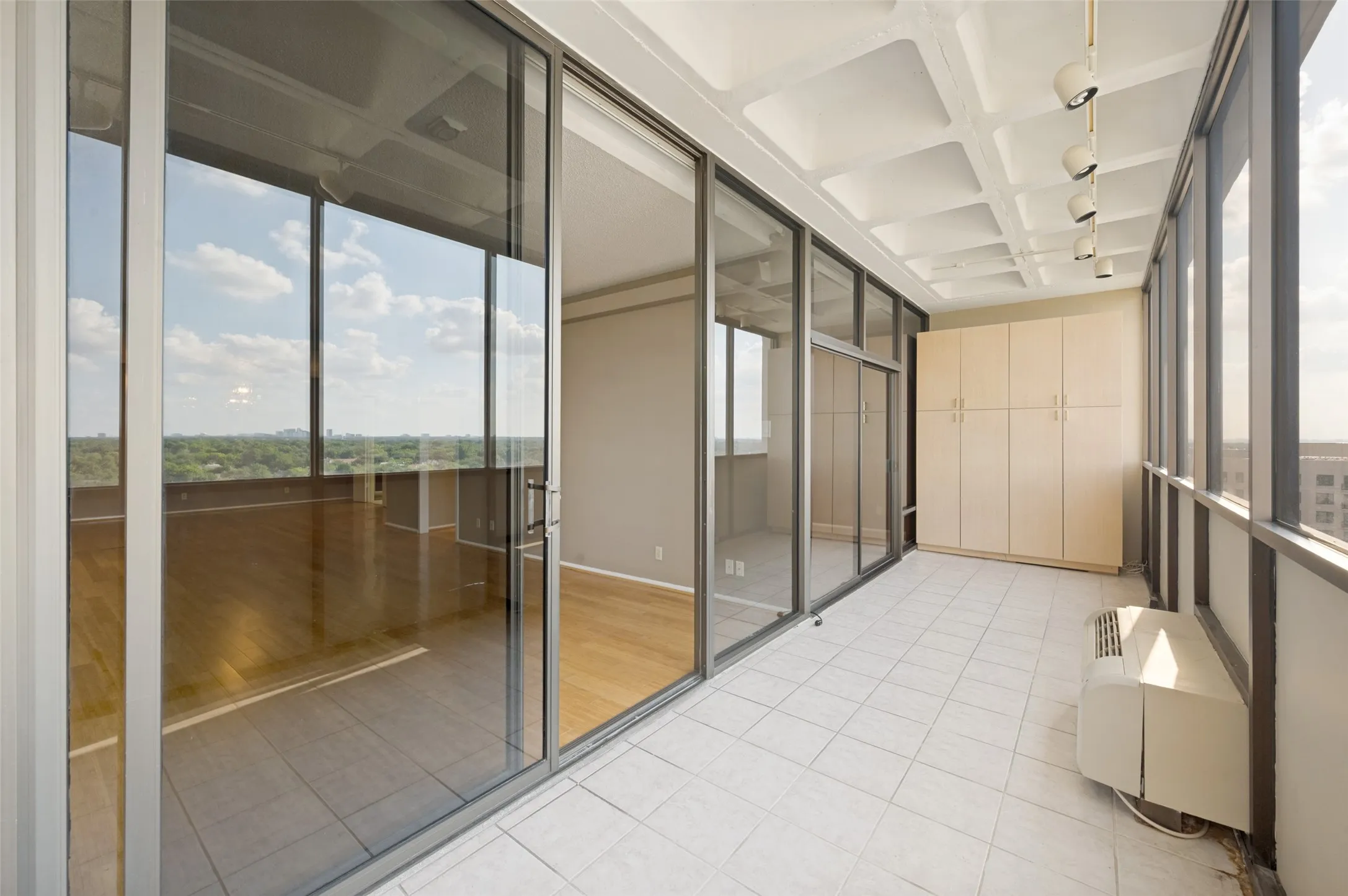 Closed in patio with spilt unit and views of Preston Hollow.