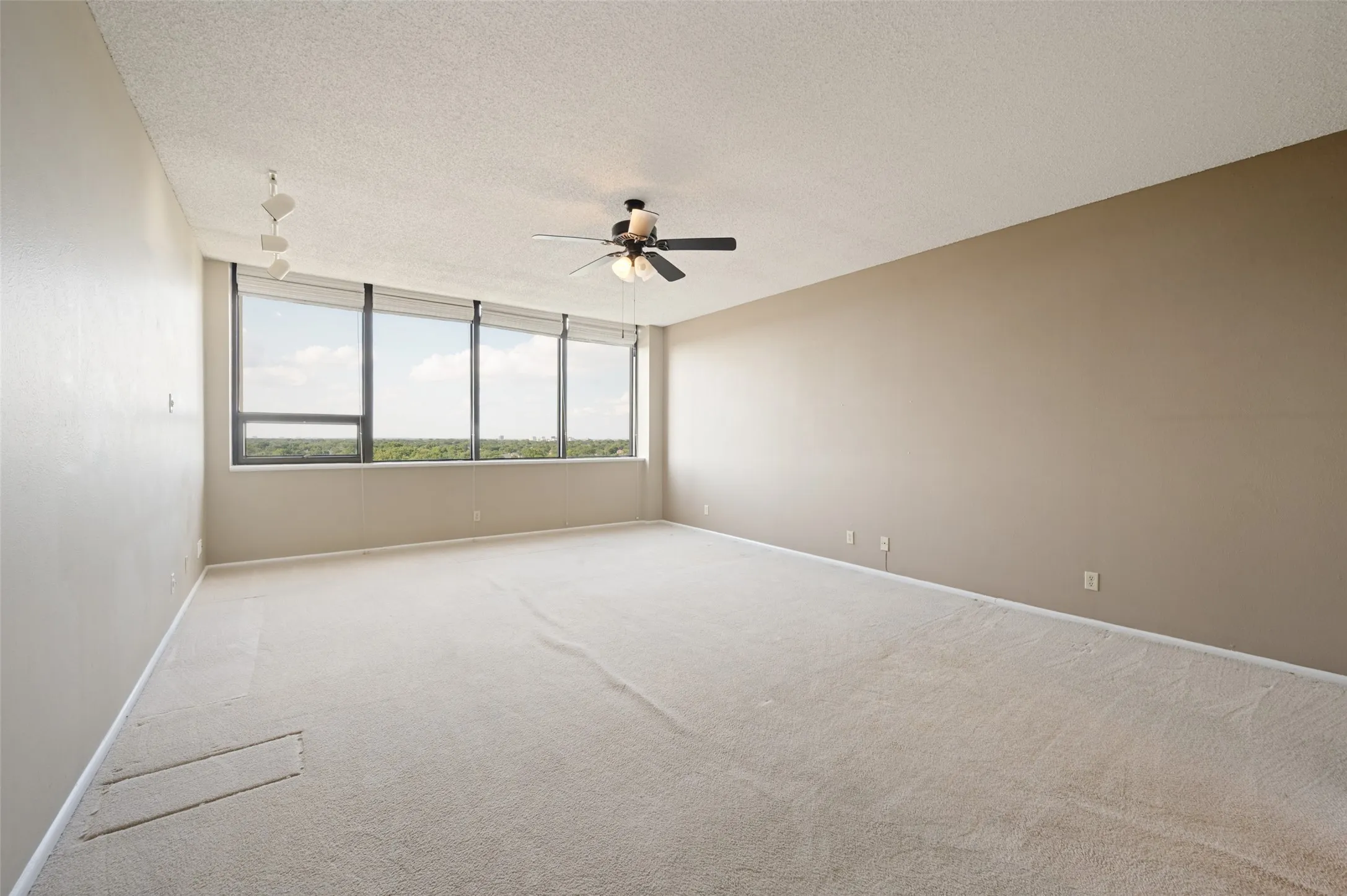 Oversized primary bedroom with views of Preston Hollow.