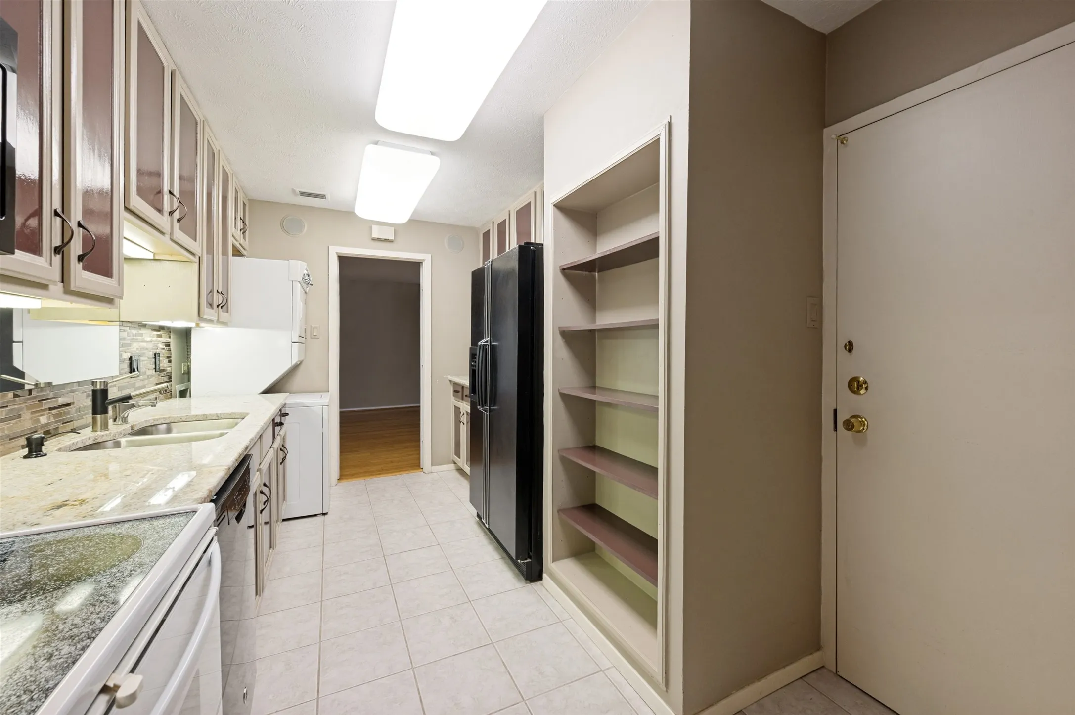 Galley kitchen with service entrance door.
