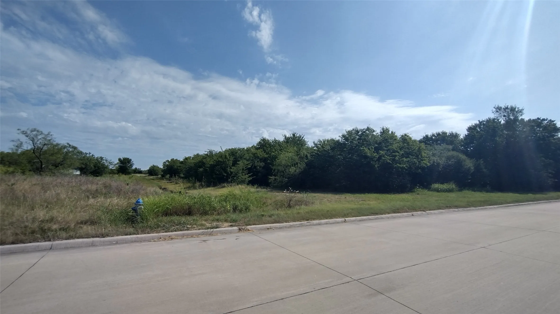 Back left hand corner. You can pretty much see the drainage ditch. The property line is in the middle.