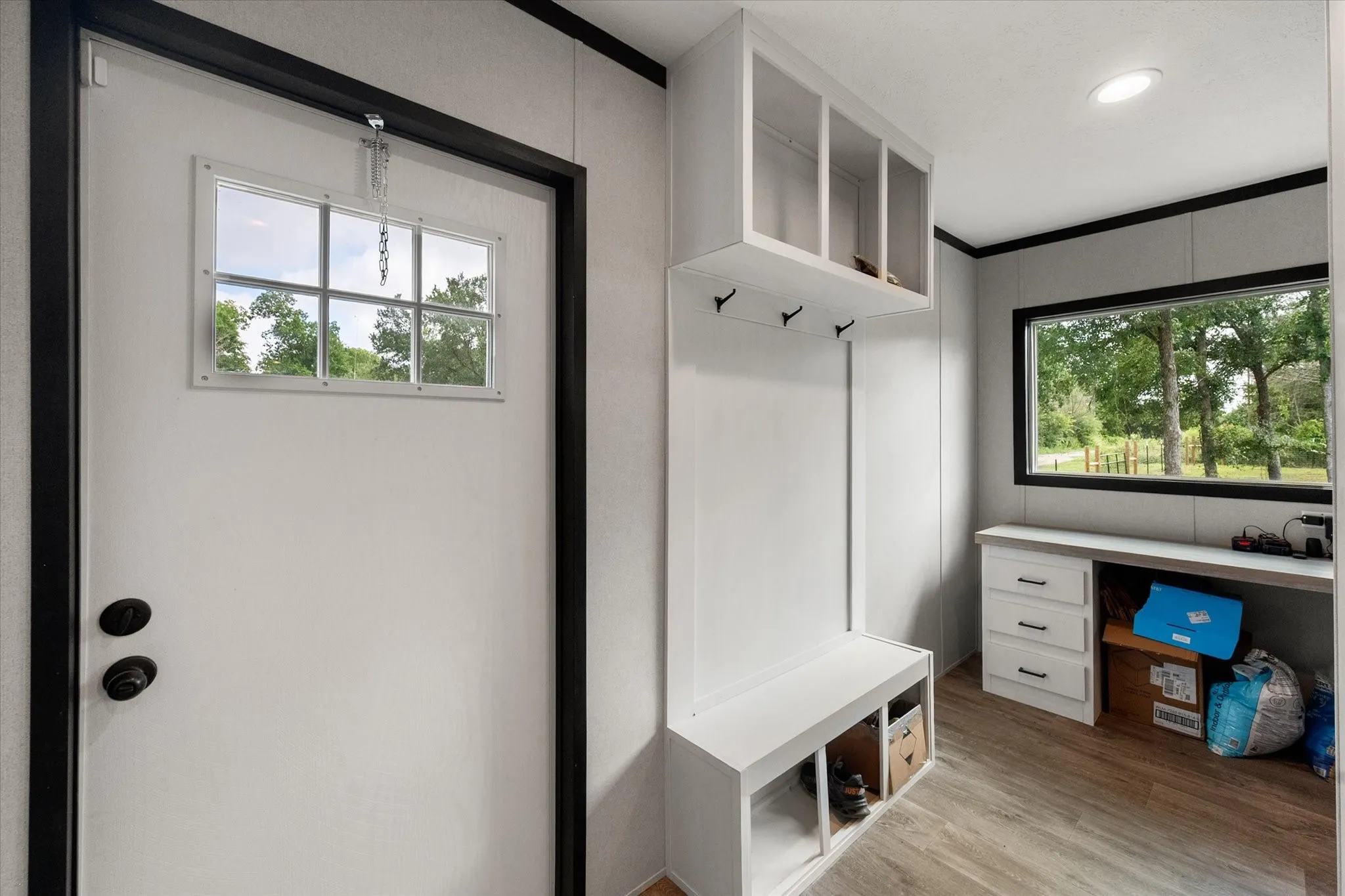 Rear entry featuring a built-in storage bench, open to the desk area.
