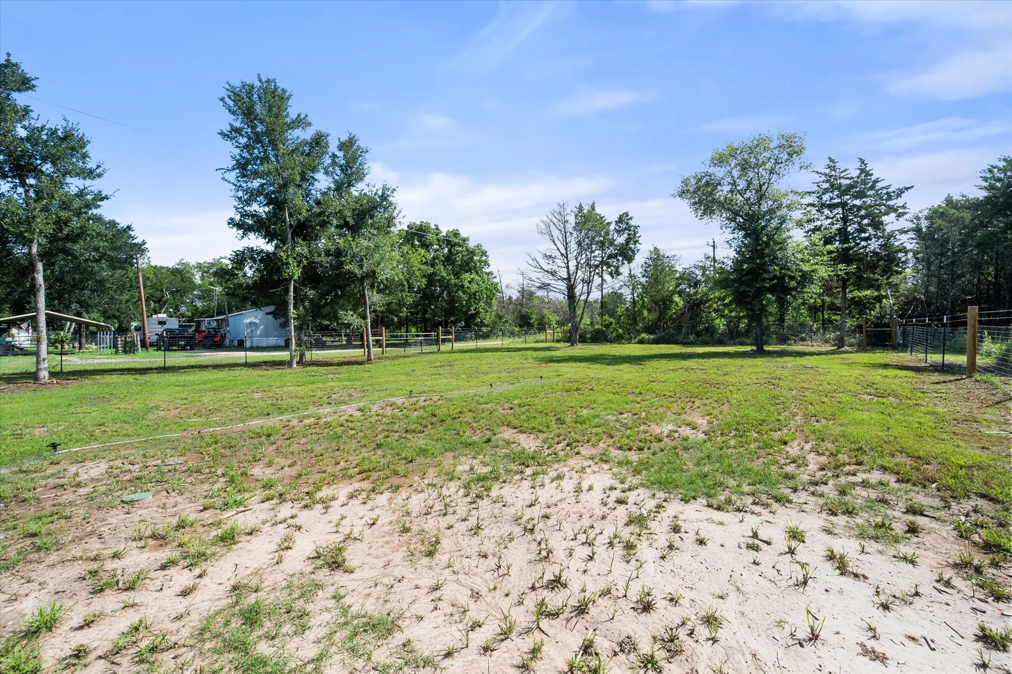 Large, fully fenced back yard with mature trees.