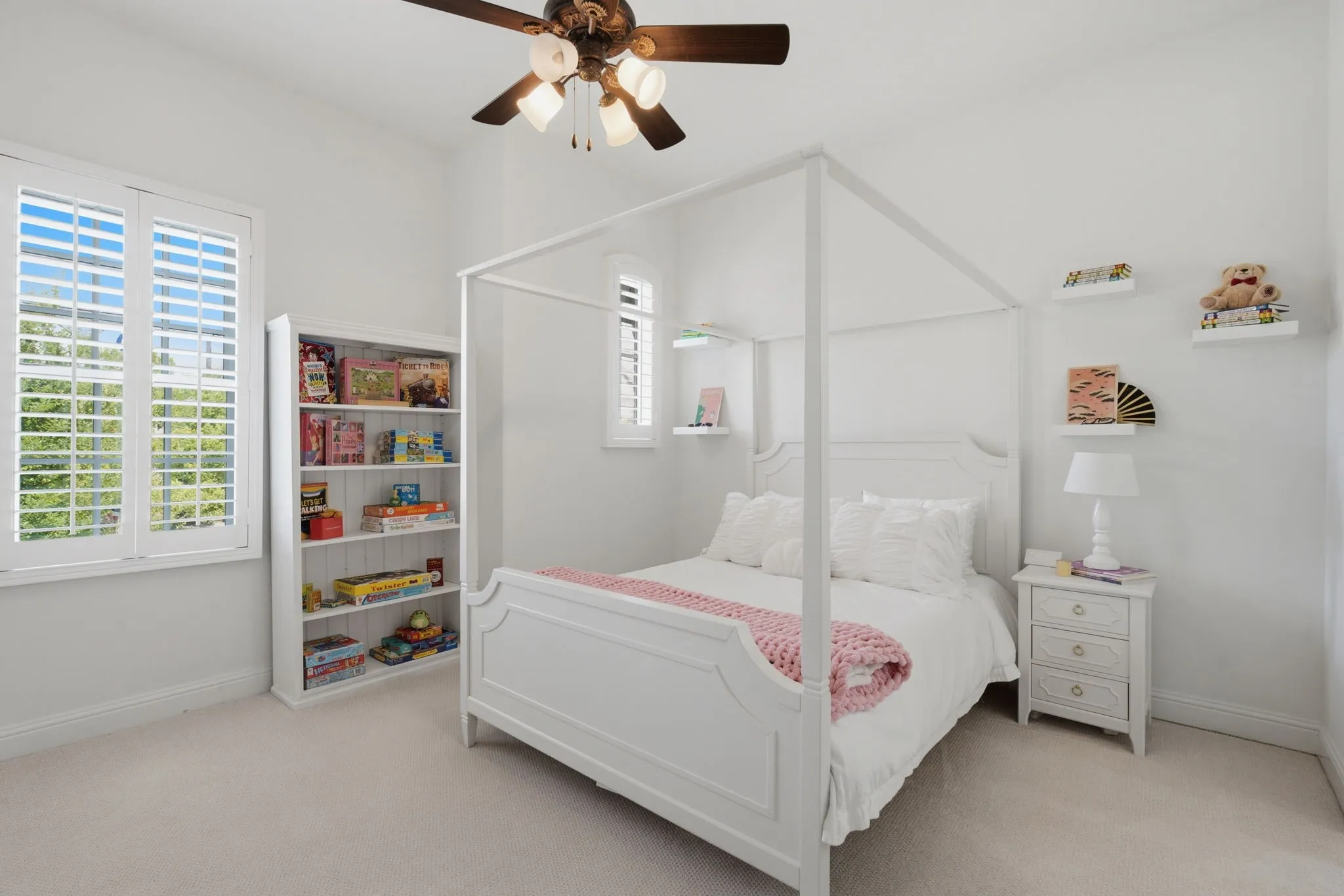 This 3rd spacious upstairs secondary bedroom is bathed in natural light and features premium plantation shutters, a modern ceiling fan for year-round comfort, and an expansive walk-in closet with custom shelving. Additionally, the room offers convenient direct access to a shared Jack & Jill bathroom, making it an ideal retreat for guests or family members.