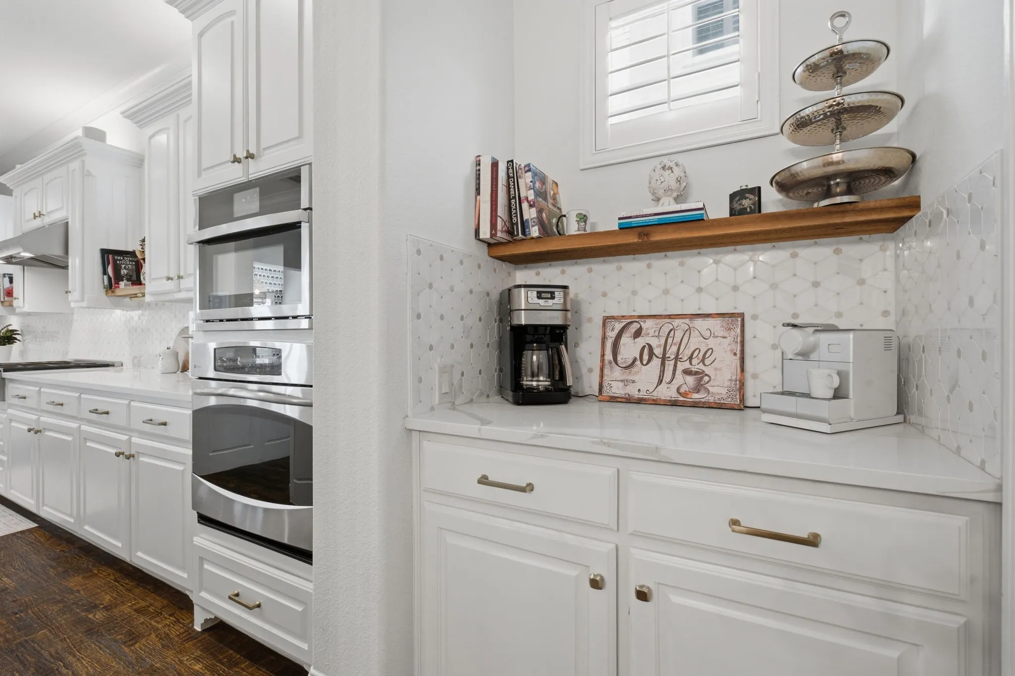 This exquisite butler's pantry offers an expansive and functional workspace, perfectly designed to house a dedicated coffee bar station. Its strategic location provides seamless access between the oversized, convenient walk-in pantry and the main gourmet kitchen, creating an ideal flow for both daily preparation and elegant entertaining.