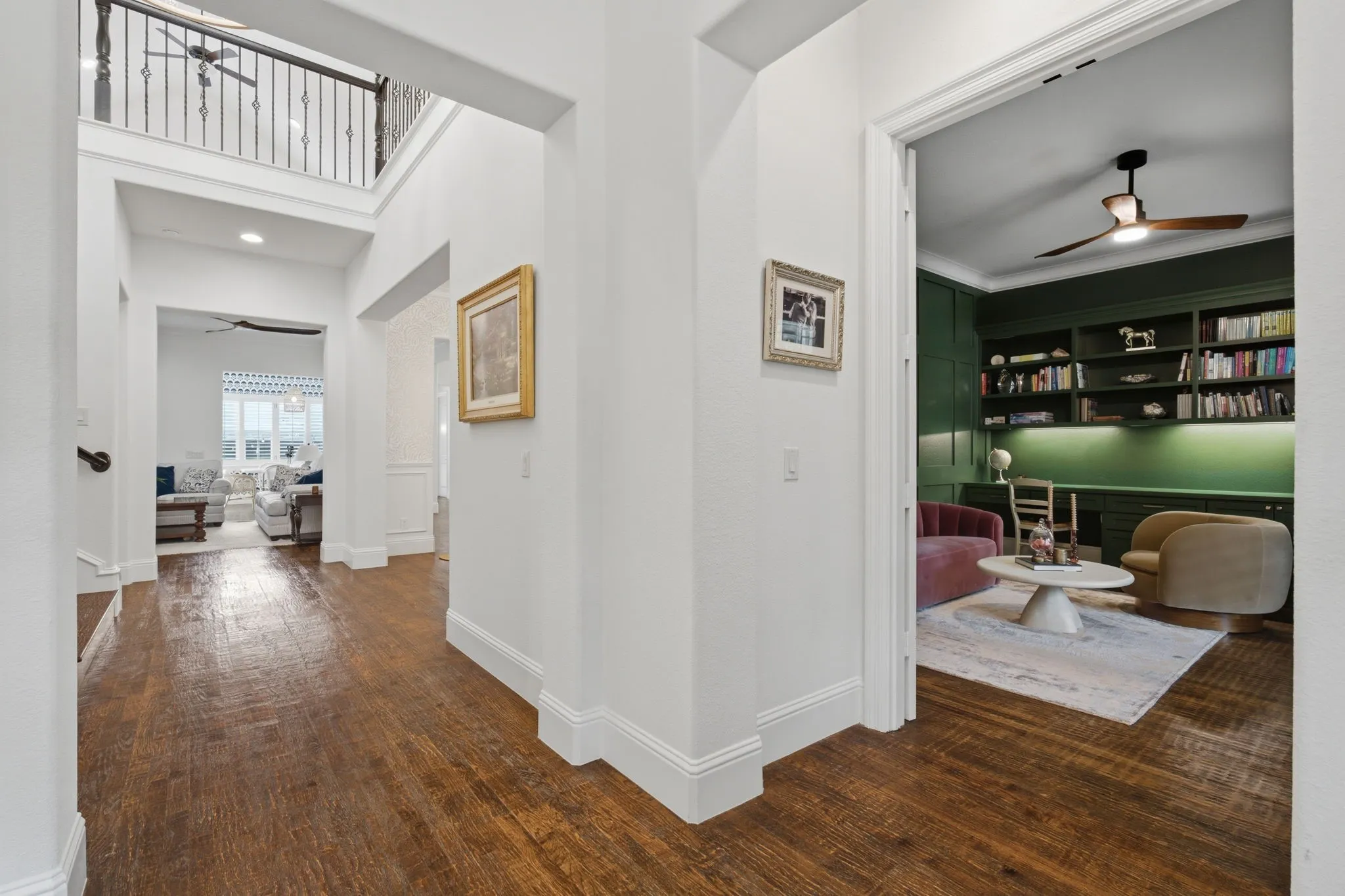 This inviting entry hall makes a fantastic first impression, featuring elegant French doors that open into a private, light-filled office space. Notice the rich, durable solid hardwood flooring that flows seamlessly from room to room, enhancing the home's cohesive and sophisticated aesthetic.