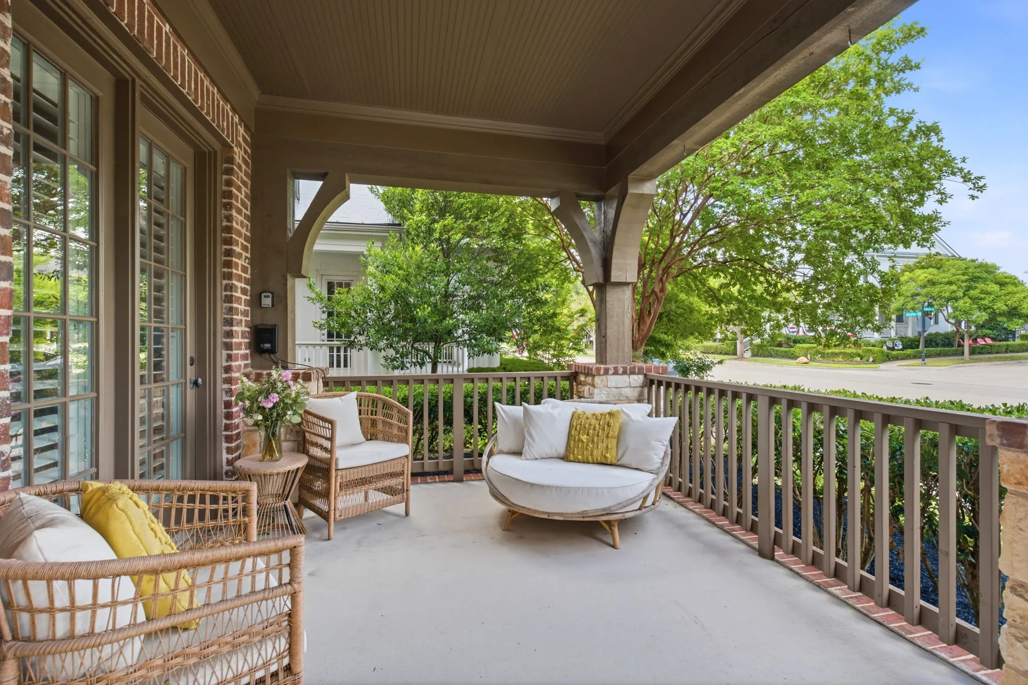 This inviting front porch serves as a dedicated, private entrance to the home office, offering a serene and refreshing outdoor space that is perfect for taking a quiet break during the busy workday.
