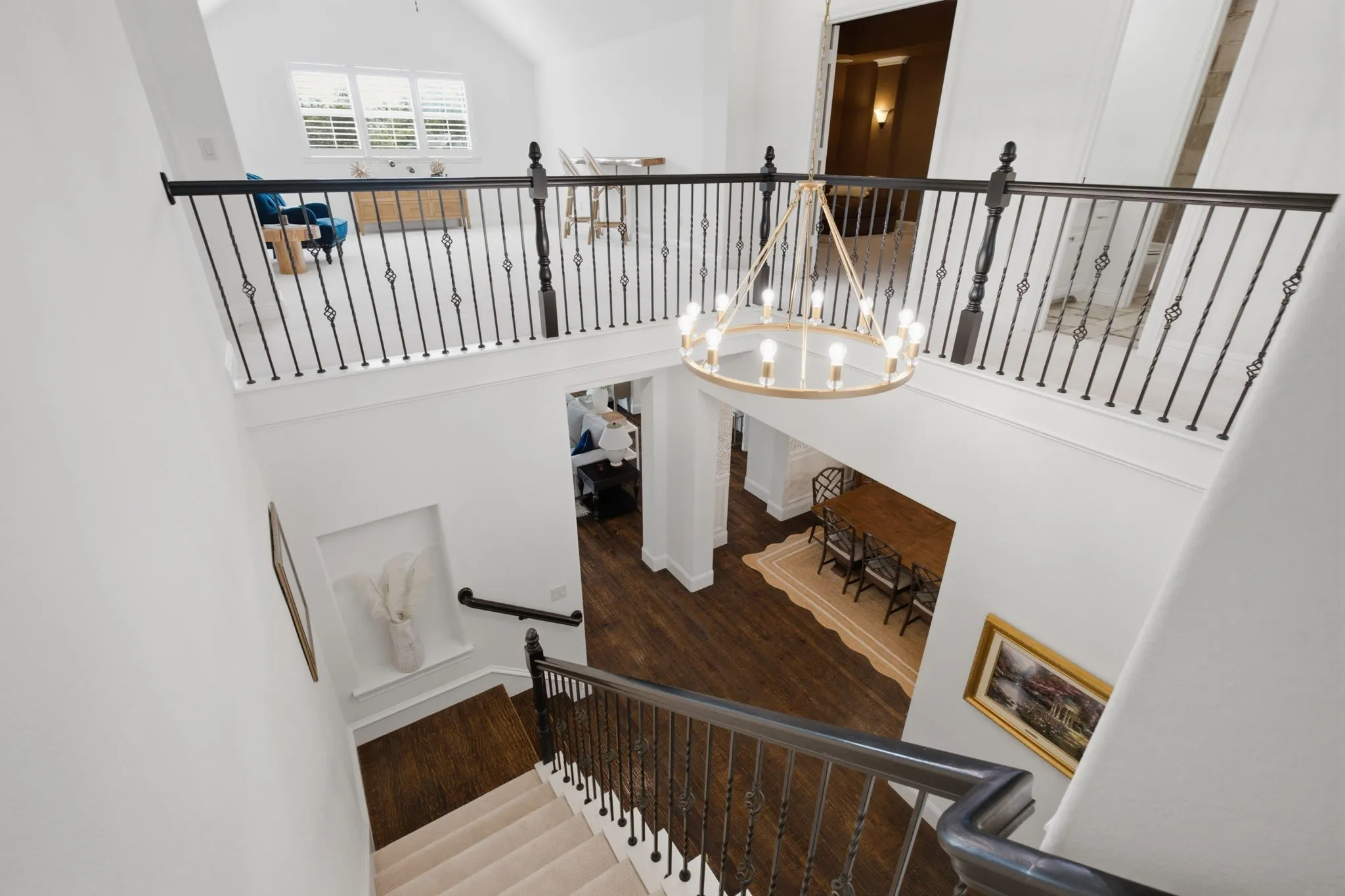 Check out this stunning view of the entrance foyer from the top of the stairs. You can see right into the game room and media room from here, which really shows off how open and flowy the home is.